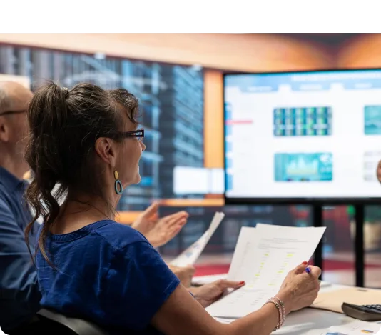 Operators monitoring building systems in a control room